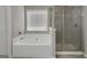 Bright bathroom featuring a soaking tub and glass-enclosed shower at 2004 Brittlebank Ln, Lawrenceville, GA 30043