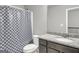 Bathroom features a toilet, vanity with granite countertop, and tiled shower with curtain at 2004 Brittlebank Ln, Lawrenceville, GA 30043