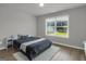 Bright bedroom with a large window, neutral walls, and comfortable carpet at 2004 Brittlebank Ln, Lawrenceville, GA 30043