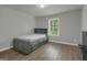 Well-lit bedroom with hardwood floors, neutral colors, and a cozy atmosphere at 2004 Brittlebank Ln, Lawrenceville, GA 30043