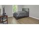 Cozy bedroom featuring hardwood floors and a comfortable bed at 2004 Brittlebank Ln, Lawrenceville, GA 30043