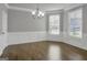 Elegant dining room featuring hardwood floors, decorative molding, a chandelier, and bright natural light from large windows at 2004 Brittlebank Ln, Lawrenceville, GA 30043