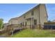 Back exterior of home with walkout basement, landscaped yard, and deck at 2004 Brittlebank Ln, Lawrenceville, GA 30043