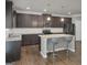Modern kitchen with stainless steel appliances, granite countertops, an island with seating, and stylish dark wood cabinets at 2004 Brittlebank Ln, Lawrenceville, GA 30043