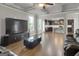 Open-concept living room with hardwood floors, coffered ceilings, and modern furnishings at 2004 Brittlebank Ln, Lawrenceville, GA 30043
