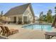 Community pool with lounge chairs and nearby covered pavillion at 2004 Brittlebank Ln, Lawrenceville, GA 30043