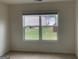 Comfortable bedroom with carpeted floors, a bright window, and neutral-colored walls at 1636 Jersey Dr, Stockbridge, GA 30281