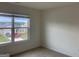 Bedroom with carpeted floors, a bright window overlooking the green yard and neighborhood views at 1636 Jersey Dr, Stockbridge, GA 30281