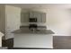 Open-concept kitchen with a center island, granite countertops, gray cabinets, and stainless steel appliances at 1636 Jersey Dr, Stockbridge, GA 30281