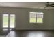 Bright living room features hardwood floors, a ceiling fan, a back yard view and access via glass doors at 1636 Jersey Dr, Stockbridge, GA 30281