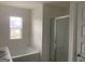 Clean main bathroom features a tub, glass-enclosed shower, vanity, and natural light from a window at 1636 Jersey Dr, Stockbridge, GA 30281