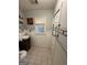 Well-lit bathroom with pedestal sink and tiled floor and window at 2119 Amherst Se Trl, Conyers, GA 30094