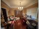 A spacious dining room with hardwood floors and a large window for natural light at 2119 Amherst Se Trl, Conyers, GA 30094