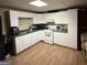 Functional kitchen with ample cabinet space, laminate flooring, and white appliances at 2119 Amherst Se Trl, Conyers, GA 30094