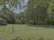 Spacious fenced backyard with large lawn, utility shed, and covered shelter at 260 Willis Rd, Sharpsburg, GA 30277