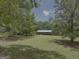 A spacious home with a large front yard and mature trees, creating a serene setting at 260 Willis Rd, Sharpsburg, GA 30277