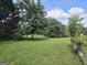 Expansive backyard with lush green grass and mature trees, providing a serene and private outdoor space at 165 Cedar Ridge Rd, Locust Grove, GA 30248