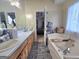 Bright bathroom with double sinks, ample counter space, wood cabinets, and a relaxing soaking tub at 165 Cedar Ridge Rd, Locust Grove, GA 30248