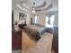 Spacious bedroom featuring a tray ceiling, carpeted floors, and a large bed with side tables at 165 Cedar Ridge Rd, Locust Grove, GA 30248