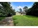 Charming single-story home featuring a welcoming front porch and surrounded by lush greenery on a sunny day at 165 Cedar Ridge Rd, Locust Grove, GA 30248