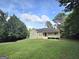 Inviting single-story home with a covered front porch and well-maintained lawn under a beautiful sky at 165 Cedar Ridge Rd, Locust Grove, GA 30248