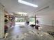 Bright and spacious garage featuring open door to outdoors, storage shelves, and tools at 165 Cedar Ridge Rd, Locust Grove, GA 30248