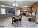 Bright eat-in kitchen featuring wood cabinetry, modern appliances, and a cozy dining area for casual meals at 165 Cedar Ridge Rd, Locust Grove, GA 30248
