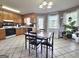 Spacious kitchen with wood cabinets, a dining area and large windows which brighten the space at 165 Cedar Ridge Rd, Locust Grove, GA 30248