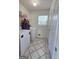 Functional laundry room equipped with a washer, dryer, and tile flooring for easy maintenance at 165 Cedar Ridge Rd, Locust Grove, GA 30248