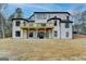 Exterior view of home with a wooden deck, set against a lush, grassy backyard at 4090 Sandy Lake Dr, Lithonia, GA 30038
