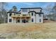 Exterior view of home with a wooden deck, set against a lush, grassy backyard at 4090 Sandy Lake Dr, Lithonia, GA 30038