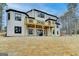 Exterior view of home with a wooden deck, set against a lush, grassy backyard at 4090 Sandy Lake Dr, Lithonia, GA 30038