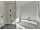 Stylish bathroom with a glass-enclosed shower and standalone bathtub at 4090 Sandy Lake Dr, Lithonia, GA 30038