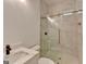 Modern bathroom with marble tile in shower and walls, glass doors and matte black and gold fixtures at 4090 Sandy Lake Dr, Lithonia, GA 30038