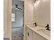 Modern bathroom with double sinks, white cabinets, and a view to another room at 4090 Sandy Lake Dr, Lithonia, GA 30038