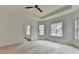 Bright bedroom with hardwood floors, tray ceiling, and multiple large windows at 4090 Sandy Lake Dr, Lithonia, GA 30038