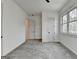 Bedroom featuring gray carpet and white trim, with a ceiling fan and natural light at 4090 Sandy Lake Dr, Lithonia, GA 30038
