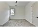 Bright bedroom featuring gray carpet, a window, and white trim throughout at 4090 Sandy Lake Dr, Lithonia, GA 30038