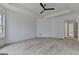 Spacious bedroom featuring hardwood floors, tray ceiling, and ample natural light at 4090 Sandy Lake Dr, Lithonia, GA 30038