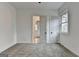 Bright bedroom featuring neutral carpet, two windows, and a glimpse of a bathroom at 4090 Sandy Lake Dr, Lithonia, GA 30038