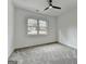 Comfortable bedroom with neutral carpet, ceiling fan, and a view of the neighborhood at 4090 Sandy Lake Dr, Lithonia, GA 30038