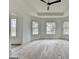 Bedroom with hardwood flooring, a tray ceiling, and large windows at 4090 Sandy Lake Dr, Lithonia, GA 30038