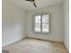 Bright bedroom with hardwood flooring, a ceiling fan, and a large window providing lots of natural light at 4090 Sandy Lake Dr, Lithonia, GA 30038