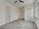 Bedroom featuring gray carpet and white trim, with a ceiling fan at 4090 Sandy Lake Dr, Lithonia, GA 30038