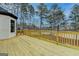 Spacious wooden deck overlooking a wooded backyard, perfect for outdoor entertaining and relaxation at 4090 Sandy Lake Dr, Lithonia, GA 30038