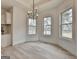 Bright dining area featuring an elegant chandelier and views of the outdoors at 4090 Sandy Lake Dr, Lithonia, GA 30038
