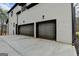 Attached two-car garage with sleek doors and ample parking space on a paved driveway at 4090 Sandy Lake Dr, Lithonia, GA 30038