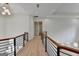 Open hallway with hardwood floors, modern railings, and recessed lighting at 4090 Sandy Lake Dr, Lithonia, GA 30038