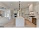 Open-concept kitchen with a large island, stainless steel appliances, and light wood flooring flowing into living area at 4090 Sandy Lake Dr, Lithonia, GA 30038
