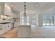 Bright kitchen features an island with marble countertop, stainless steel appliances, and adjacent dining area at 4090 Sandy Lake Dr, Lithonia, GA 30038
